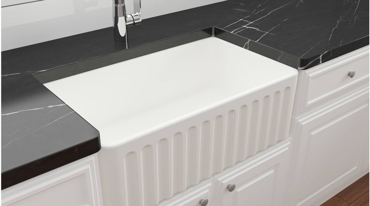 Novi 75 x 46cm fireclay butler sink in matte white set into a dark stone benchtop